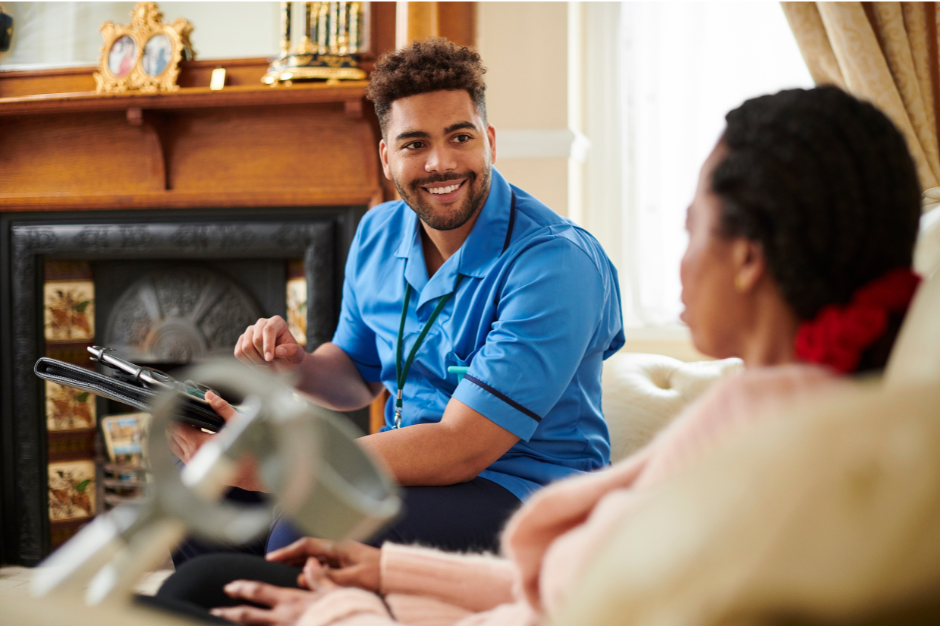 care at home male carer smiling towards a service user